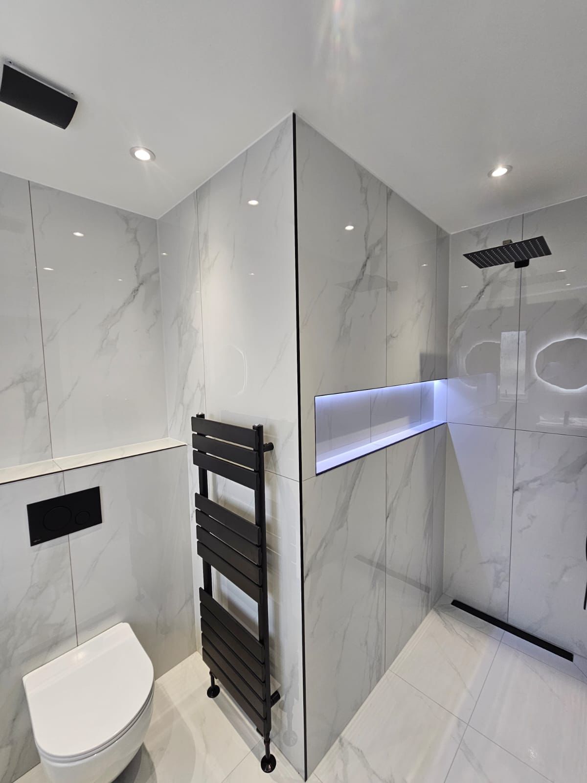 Premium polished porcelain wall and floor tiles in elegant Statuario marble finish.