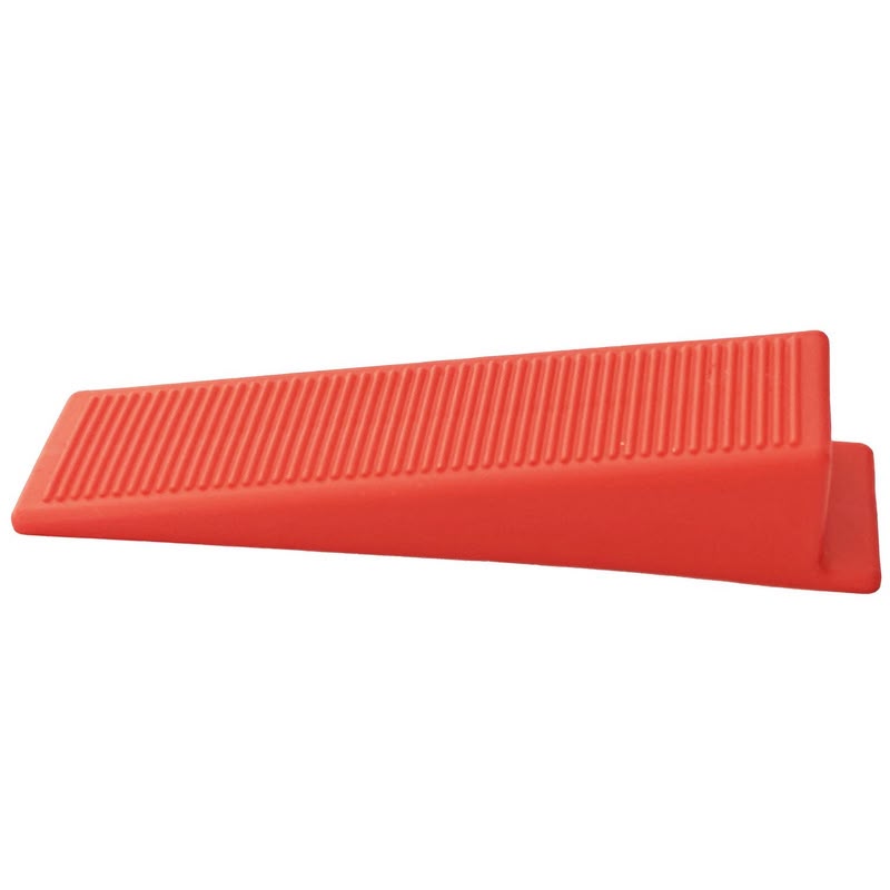Red tile levelling wedges for accurate tile alignment and even surfaces, ideal for professional tiling