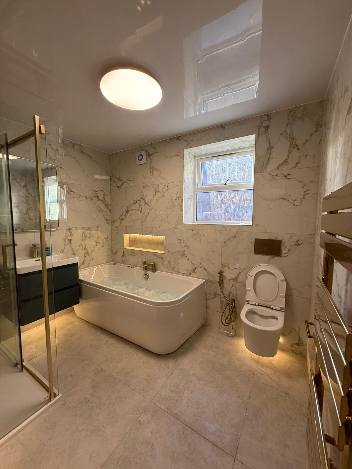 Large format porcelain wall and floor tiles with glossy marble design and soft gold veins