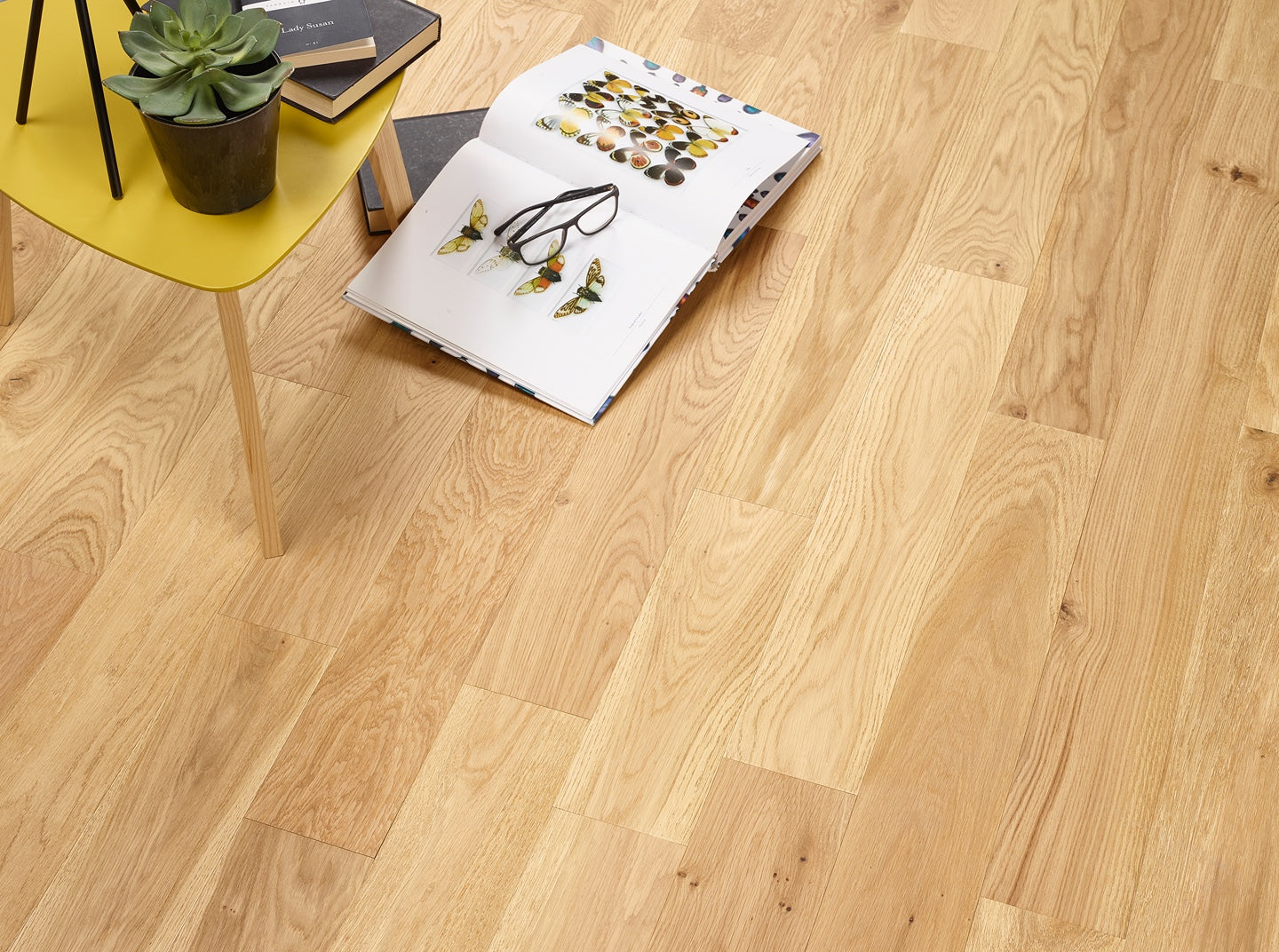Natural brushed and oiled engineered wood flooring in herringbone tongue and groove design.
