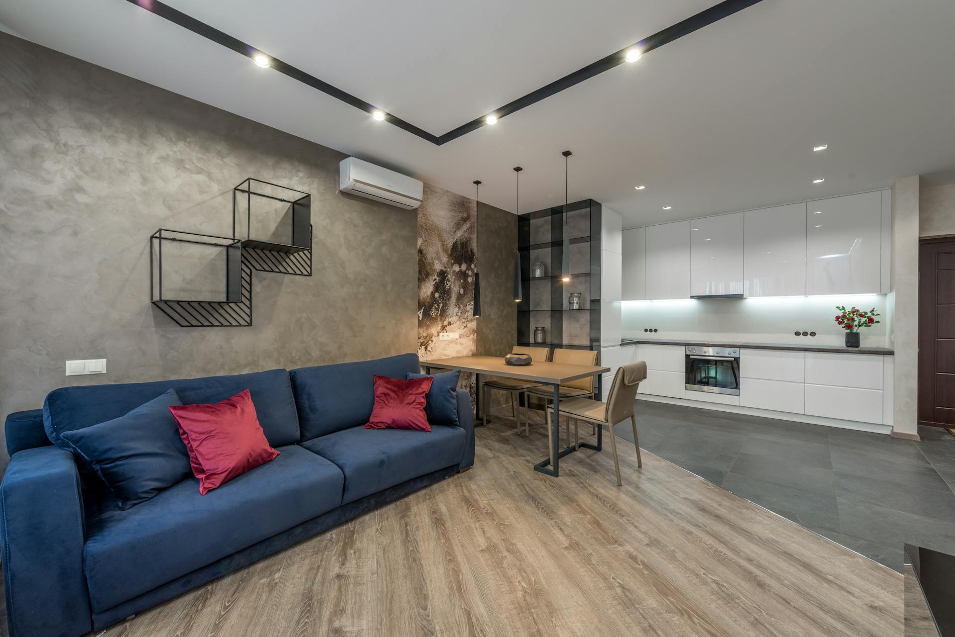 Interior design of luxury living room having light brown teak wood decking on floor.