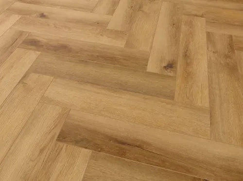 Rigid Core SPC Oak Herringbone Flooring with natural wood texture, suitable for underfloor heating and commercial use.