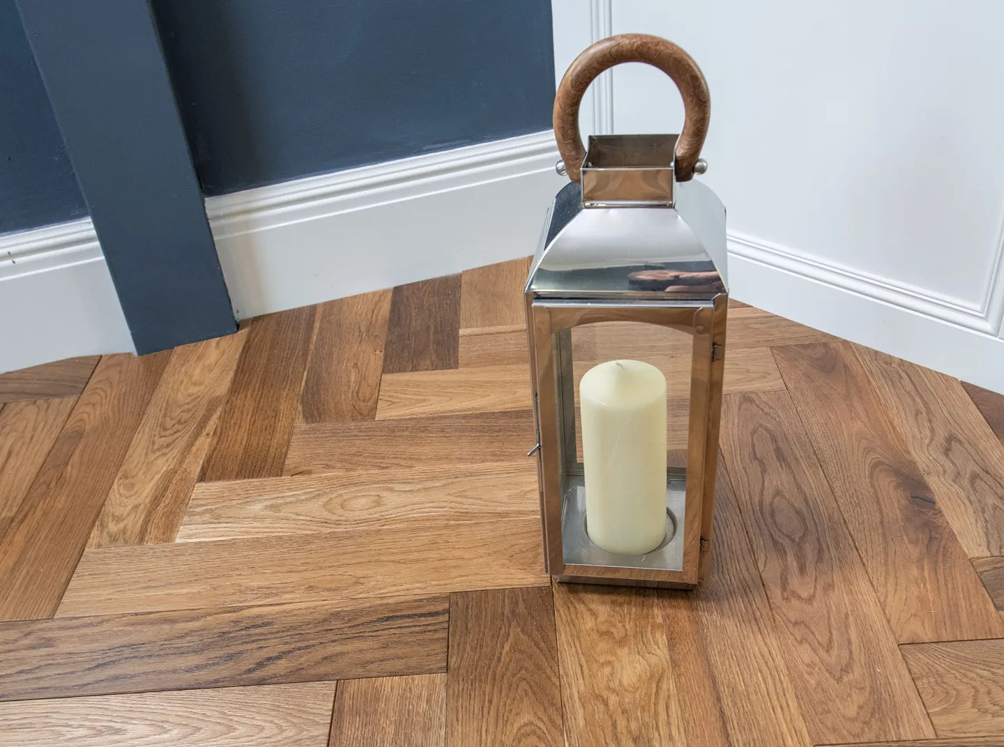 Smoked brushed and lacquered oak engineered wood flooring in elegant herringbone design.