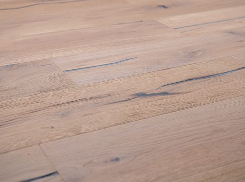 Smoked white oak flooring with distressed finish, highlighting natural grain patterns for a warm, elegant interior.